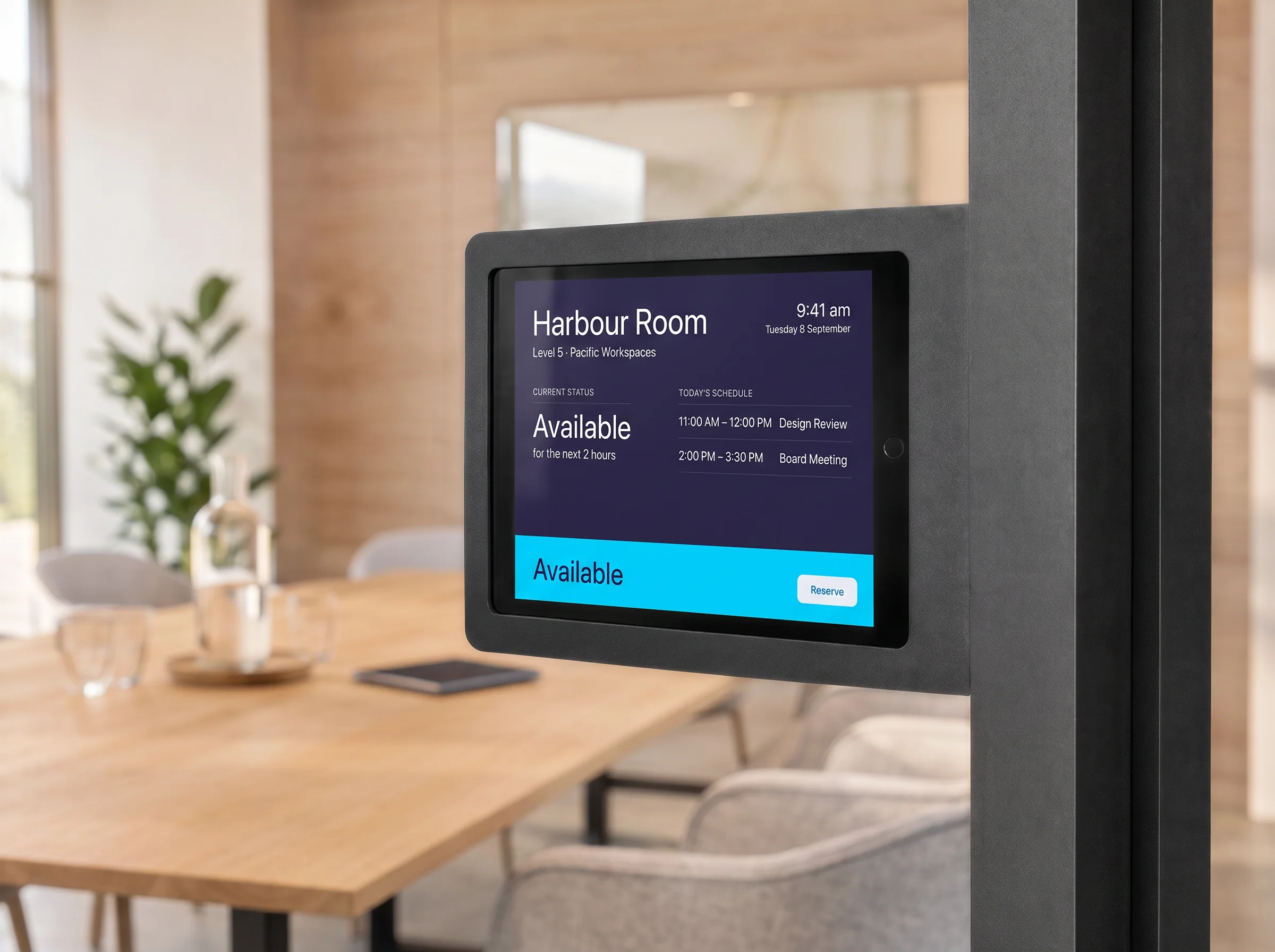 iPad room-booking display in a Heckler mount