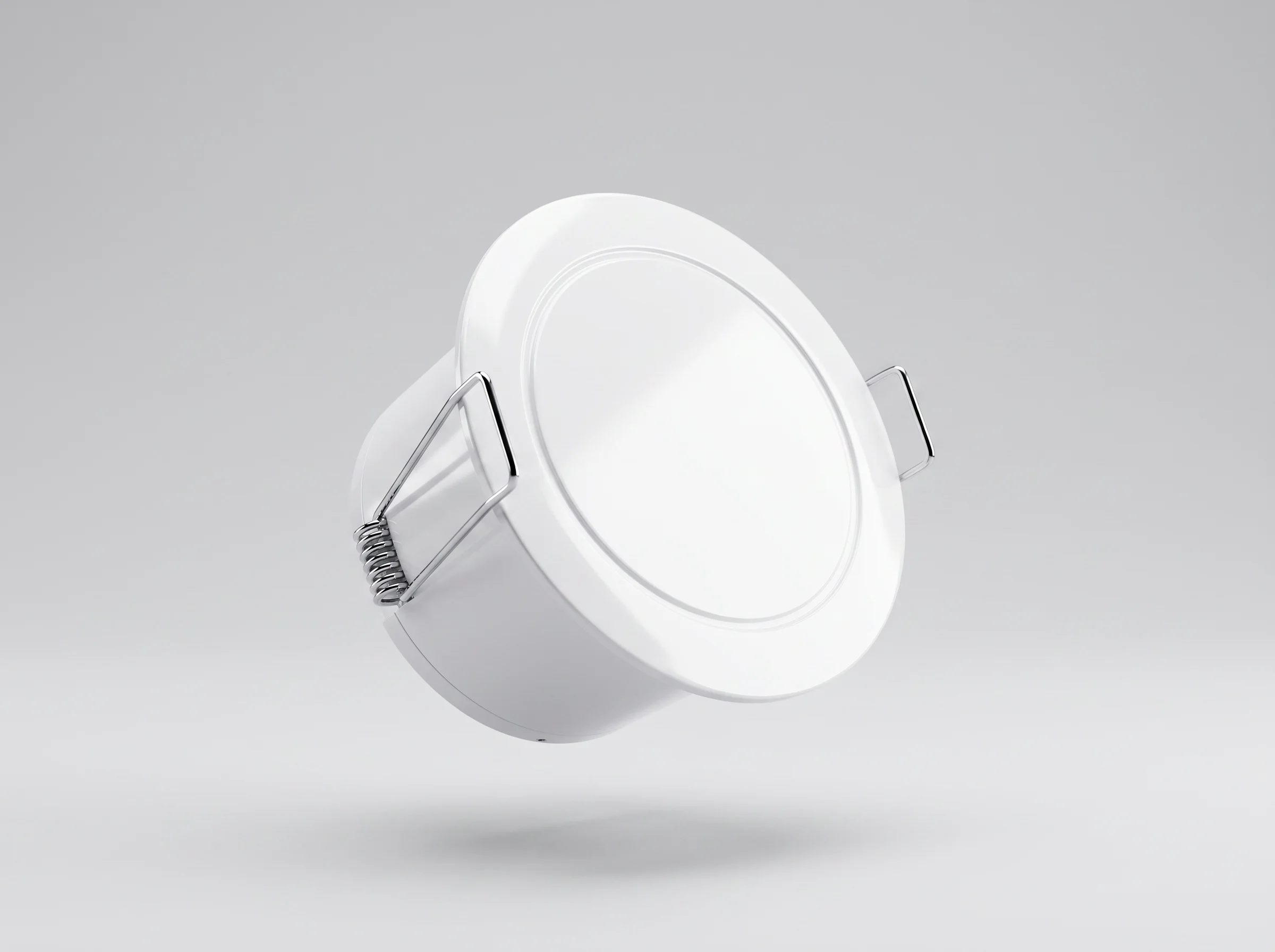 Angled view of a round white Room Occupancy Sensor with mounting clips